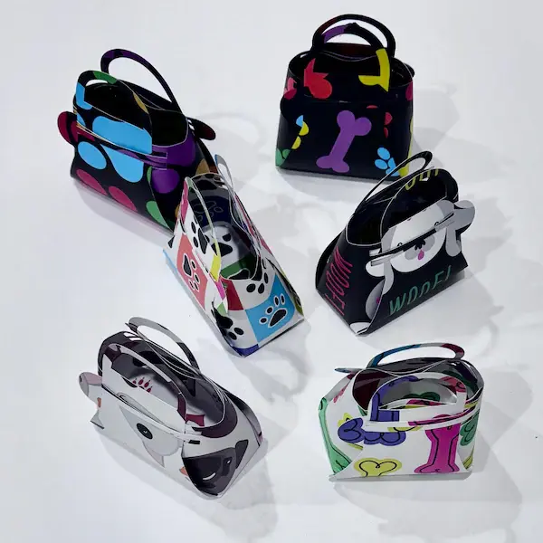 Mini paper gift bags shaped like purses with dog prints